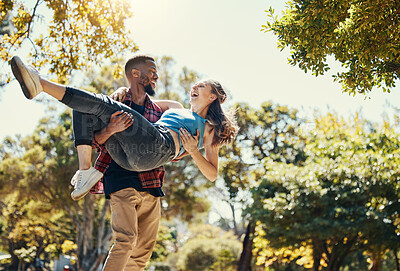 Buy stock photo Young interracial couple, park and man carrying woman on summer date in garden, sunshine fun or relax, love and care together. Happy couple, smile and diversity people in nature for relationship play
