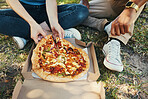 Friends, park and pizza with people relaxing outside for bonding, fun and fast food enjoyment. Consumables, junk food and man and woman relaxing in a garden while eating carbs and takeaway food