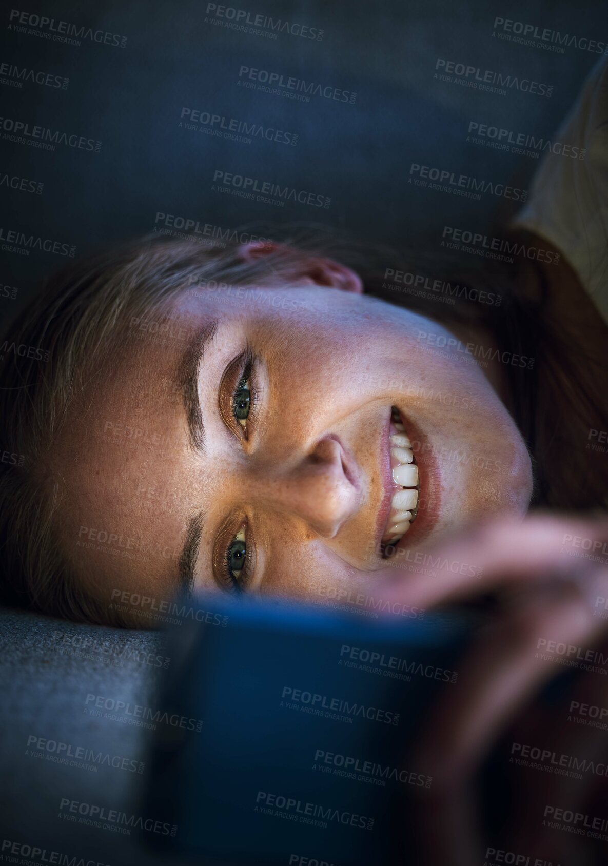 Buy stock photo Woman, phone or lying on sofa at night in house or home living room on online dating app, social media or internet esports game. Smile, happy or relax student on mobile technology social network news