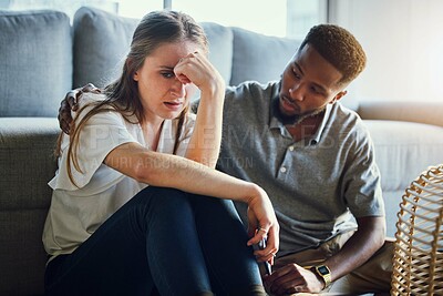 Buy stock photo Depression, sad and compassion with a man and woman comforting or consoling in a home living room. Couple, love and support with a male and female together in trust, hope or empathy for mental health