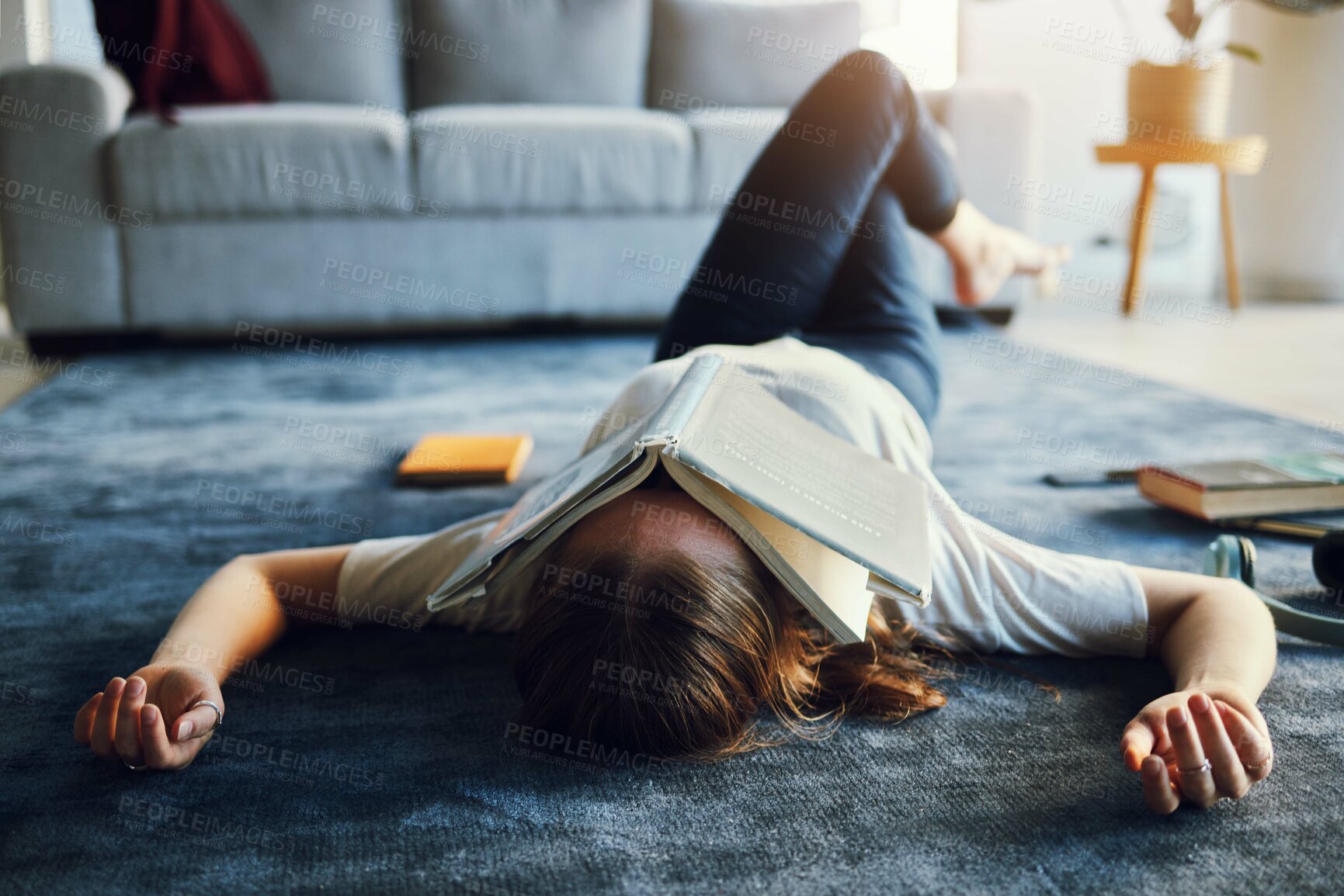 Buy stock photo Book, student and university burnout with girl and exhausted on living room carpet, education and study for exam. Lying on floor, tired and overworked with stress about college with notebook.