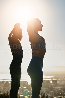 Buy stock photo Fitness, sunset and couple doing an outdoor exercise or training together on a rooftop in the city. Sports, healthy and athletes stretching before workout on roof of a building outside in urban town.