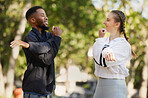 Interracial, couple and stretching for wellness, training and exercise for workout and bonding in park. Healthy, man and woman outdoor for fitness, practice and together to relax, health and speaking