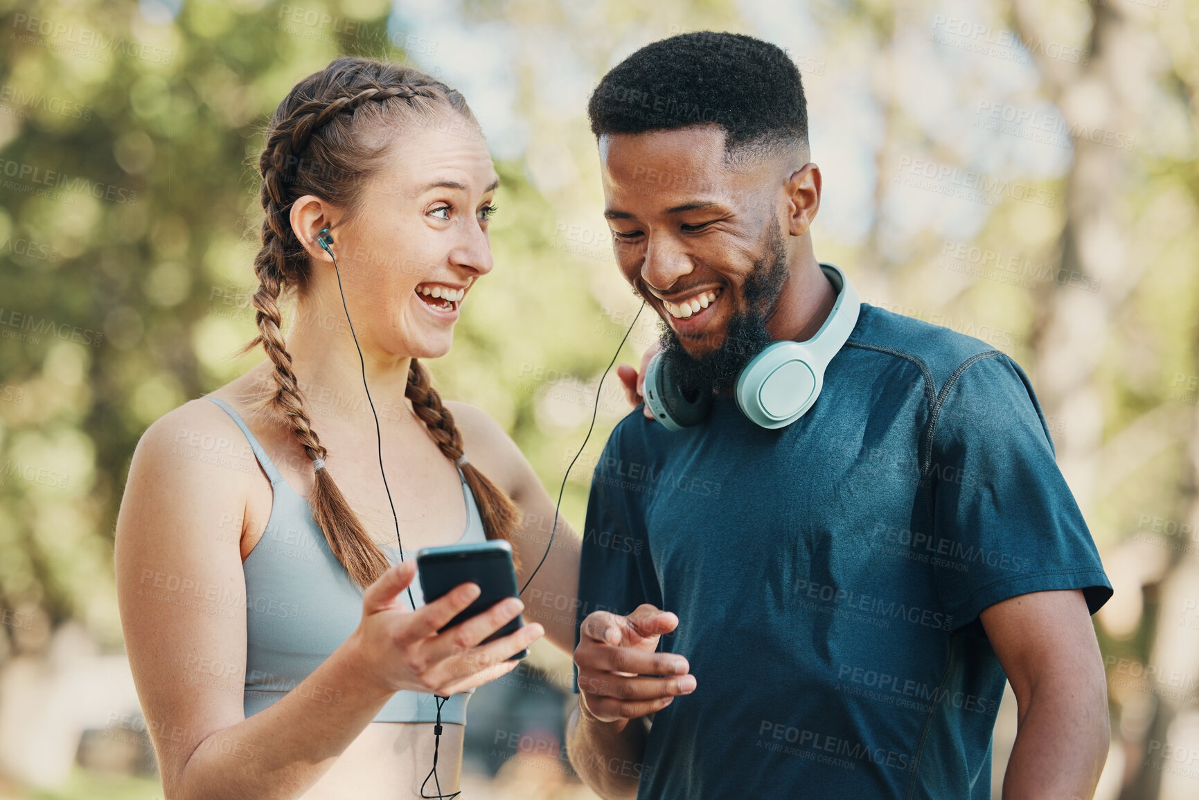 Buy stock photo Phone, music and fitness with a diversity couple listening to audio while outdoor for running exercise together. Happy, fun and streaming with a man and woman athlete outside for a training workout