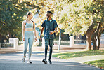 Workout, fitness and couple walk in nature together for wellness, bond and health in summer. Exercise and healthy lifestyle of people in interracial relationship walking in New York park. 

