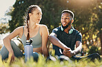 Relax, man and woman on grass, for wellness and exercise for health, workout and rest together. Couple, black male and female talking, fitness and break in nature, outdoor and speaking after training
