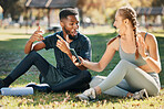 Music, phone and earphone couple in park on fitness run break rap, singing and listen together. Streaming, tech and interracial people listening to feel good beats with mobile app to relax.