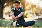 Health, black man and stretching outdoor for exercise, fitness or wellness with breathing and focus. Healthy male, athlete or training for workout, balance or endurance for cardio, power and on grass