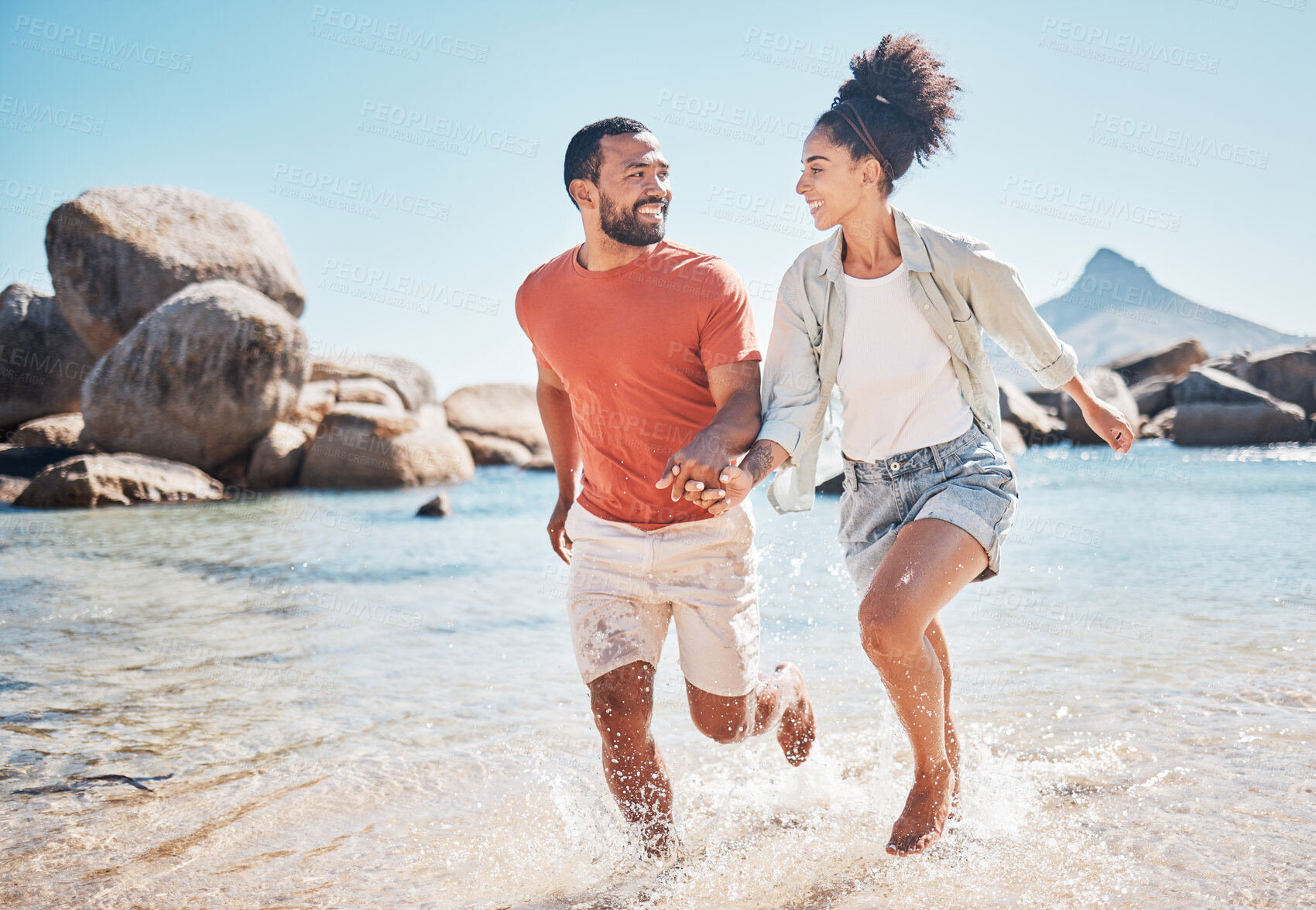 Buy stock photo Black couple, beach and running while holding hands on vacation in summer by the sea for energy, love and care while bonding and spending quality time. Man and woman together on holiday in Bali 