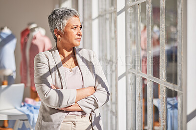 Buy stock photo Woman, thinking and arms crossed at office window for vision, planning work or fashion startup idea motivation. Clothes design manager, creative leader and stratergy dream or workplace inspiration