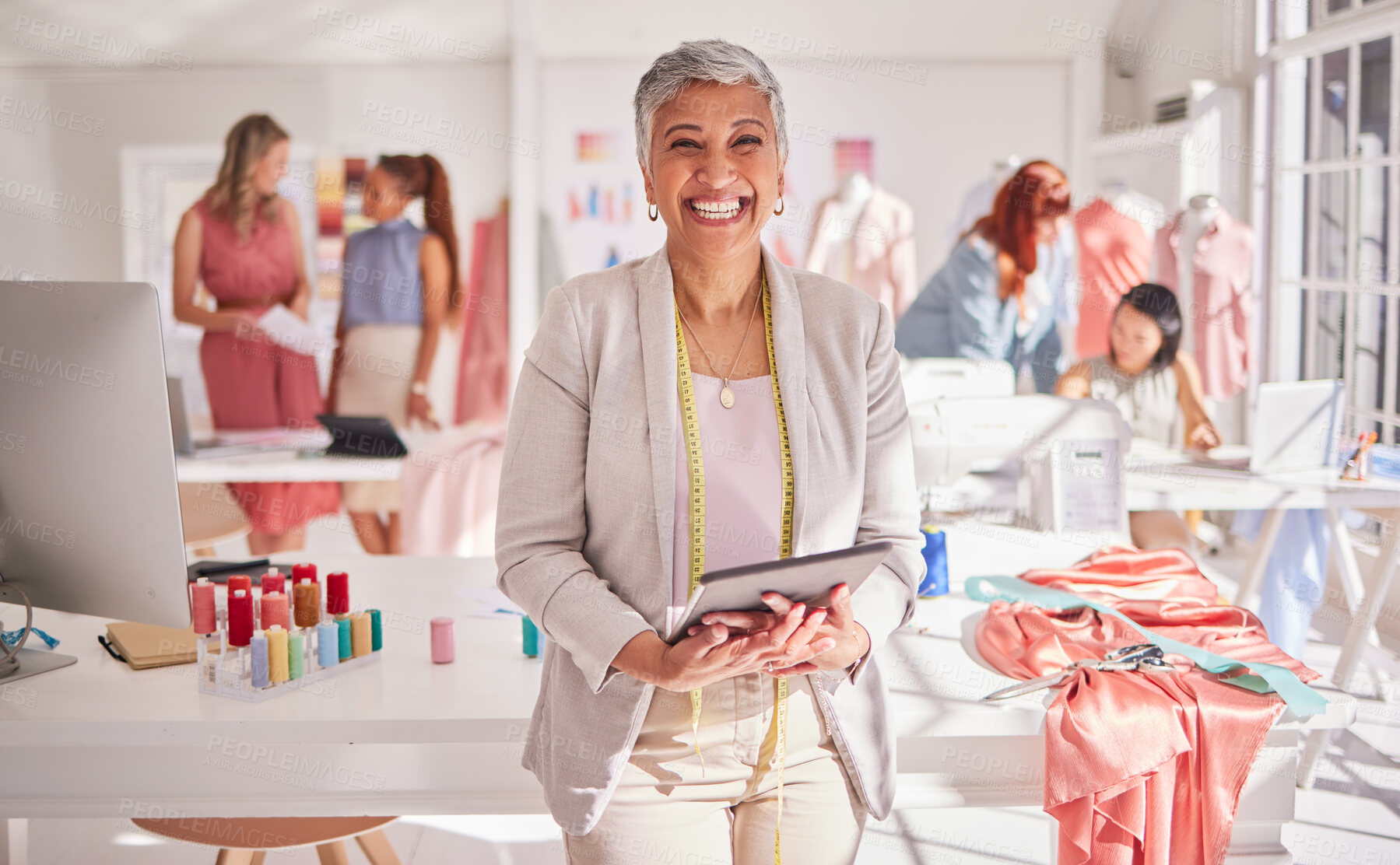 Buy stock photo Retail, fashion and elderly woman with tablet for design management, ecommerce and inventory at a workshop with workers. Portrait, senior and small business owner excited about online store order