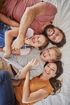 Buy stock photo Happy family, love and relax in bed with children and parents laughing, bond and resting in their home together. Parents, kids and laughter in a bedroom, enjoying a lazy day at home with top view