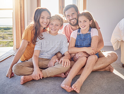 Buy stock photo Relax, happy and portrait of family on floor of bedroom for weekend, bonding and affectionate. Smile, quality time and support with parents and children at home for youth, lifestyle and having fun