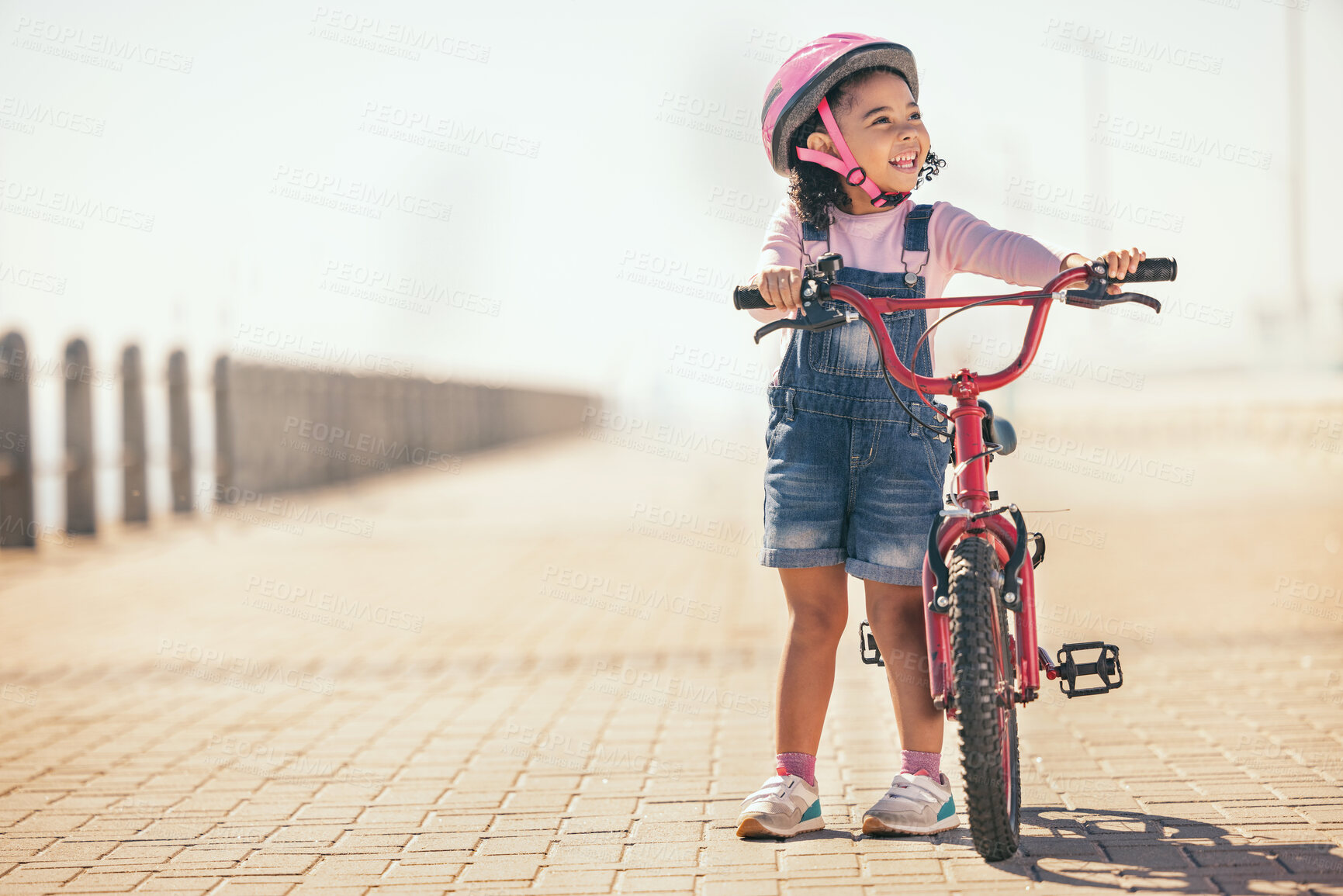 Buy stock photo Fun, thinking and girl cycling with a bike in the city for sustainability, carbon footprint and eco friendly transport. Happy, smile and child with an idea and a bicycle in the street for happiness