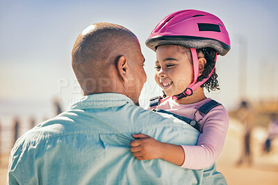 Buy stock photo Family, love and girl with dad and helmet for safety before cycling together at park outdoors, happy and hug. Children, learning and father embrace daughter, bonding and talking before riding a bike