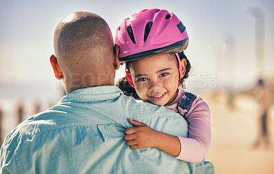 Buy stock photo Father, bicycle and girl portrait of a young kid with a helmet by the sea ready for cycling learning. Family, holiday and fun of a dad and child hug with happiness and bike gear excited for activity