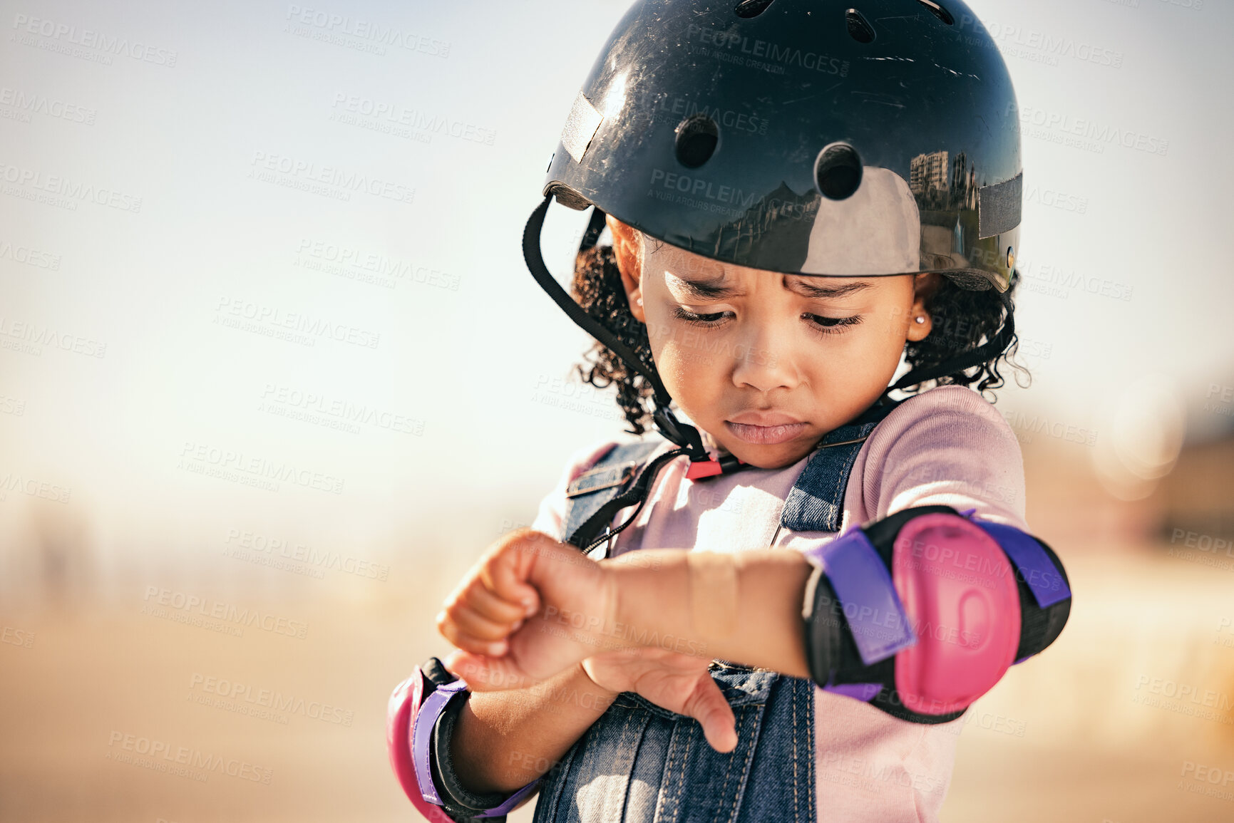 Buy stock photo Cycling injury, child and pain from a bike accident outdoor feeling stress and sadness. Young girl and summer cyclist or skating activity with a helmet and safety gear with arm bruise problem