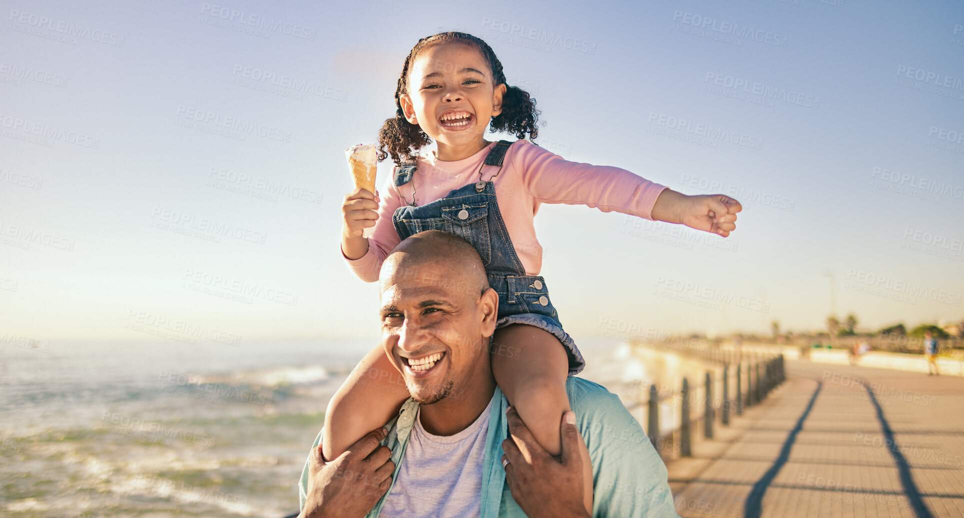 Buy stock photo Family, children and piggyback with a father and daughter eating ice cream while walking on the promenade together. Sky, nature and kids with a man and girl bonding with the sea or ocean at the beach