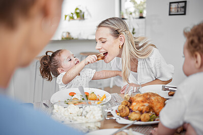 Buy stock photo Happy family, mother and child eating chicken and vegetables in a healthy meal for dinner in Germany, Berlin. Food, nutrition and young girl feeding her hungry mom lunch at a home dining room table 