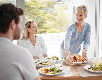 Buy stock photo Family, lunch and food for dining, meal and happy at table for celebration event, eating and happiness together. Hosting, family home and thanksgiving feast with cheerful people sharing and fresh