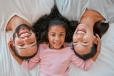 Buy stock photo Top view, family smile and portrait in bedroom home, having fun and bonding. Care, love and happy girl kid, mother and father enjoying good time together, smiling and laughing while relaxing in house