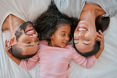 Buy stock photo Top view, love and parents with child in bed bonding, smiling and enjoy morning together. Family, happiness and aerial of young girl in bedroom for quality time, affection and relax with mom and dad