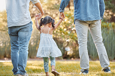 Buy stock photo Holding hands, park and girl with father and grandfather walking, support and trust in nature. Peace, love and back of a child with family men on a walk on a field in the countryside in summer