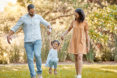 Buy stock photo Park, family and holding hands with flying child for fun, bond and wellness walk together. Happy, mother and dad with young daughter in Canada playing in nature for summer sunshine leisure.