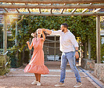 Couple, happy dancing together and outdoor love to celebrate relationship, cute dance spin and relationship activity. Woman laughing, romantic man and sunset summer romance date at nature restaurant 