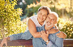 Nature, bench and portrait of a senior couple relaxing in an outdoor green garden together. Happy, smile and elderly man and woman in retirement embracing, bonding and sitting in a park in Australia.