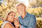 Love, nature and old couple holding hands on vacation outdoors on a calm or peaceful in summer. Happy, old man and senior woman enjoy quality time, hug or bonding in a park for freedom in retirement 