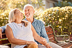 Senior date, love and couple with care in park for peace, relax and calm during retirement. Smile, affection and elderly man and woman in the backyard or garden of a home for conversation on a bench