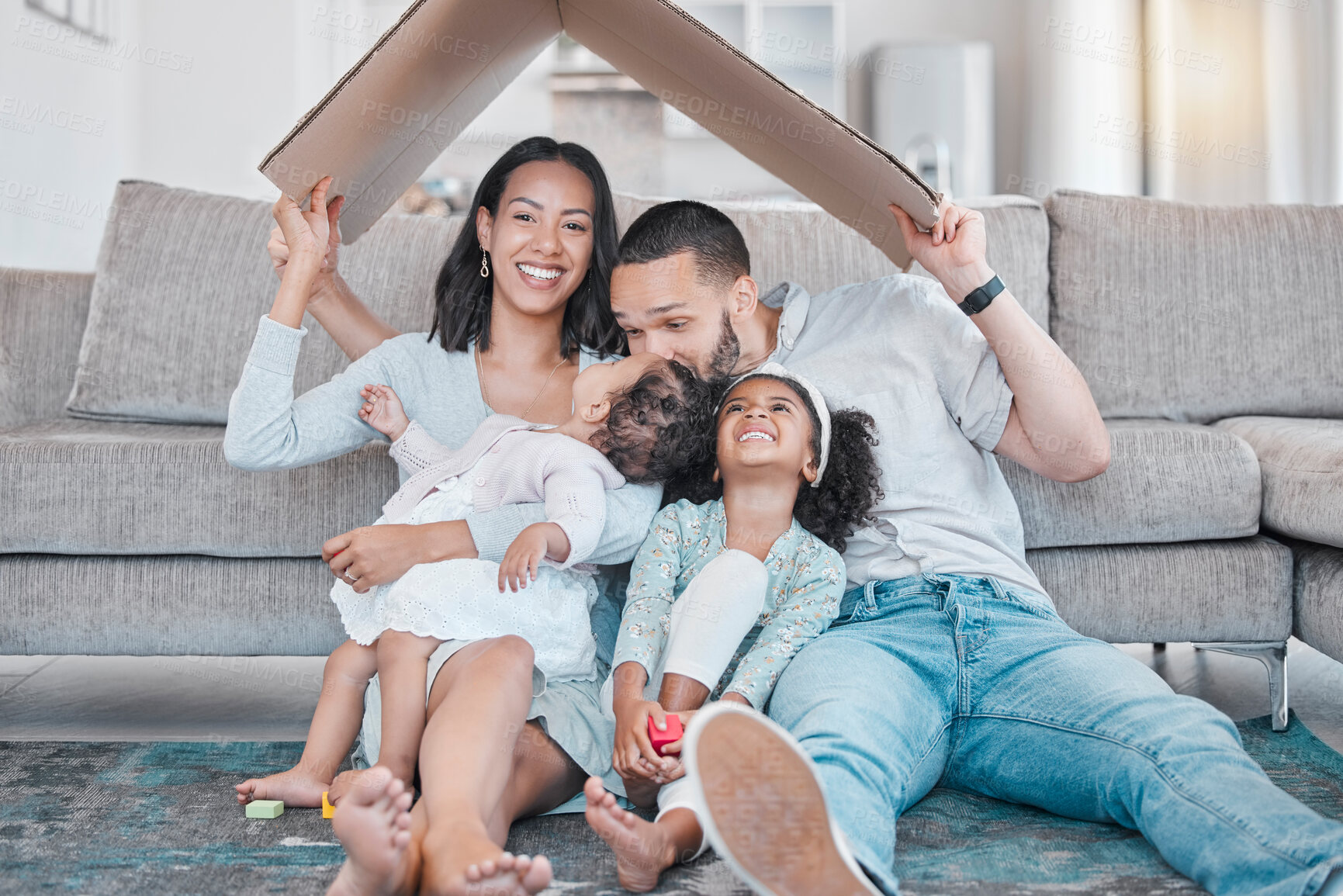 Buy stock photo Happy family, cardboard roof or house life insurance in home living room floor in security, mortgage loan success or investment support. Property cover for smile, happy mother or father and children