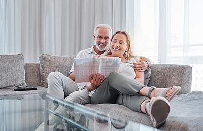 Buy stock photo Senior couple reading book on sofa together enjoying weekend, freedom and retirement at home. Love, relaxation and mature man and woman read novel bonding, smiling and sitting on couch in living room