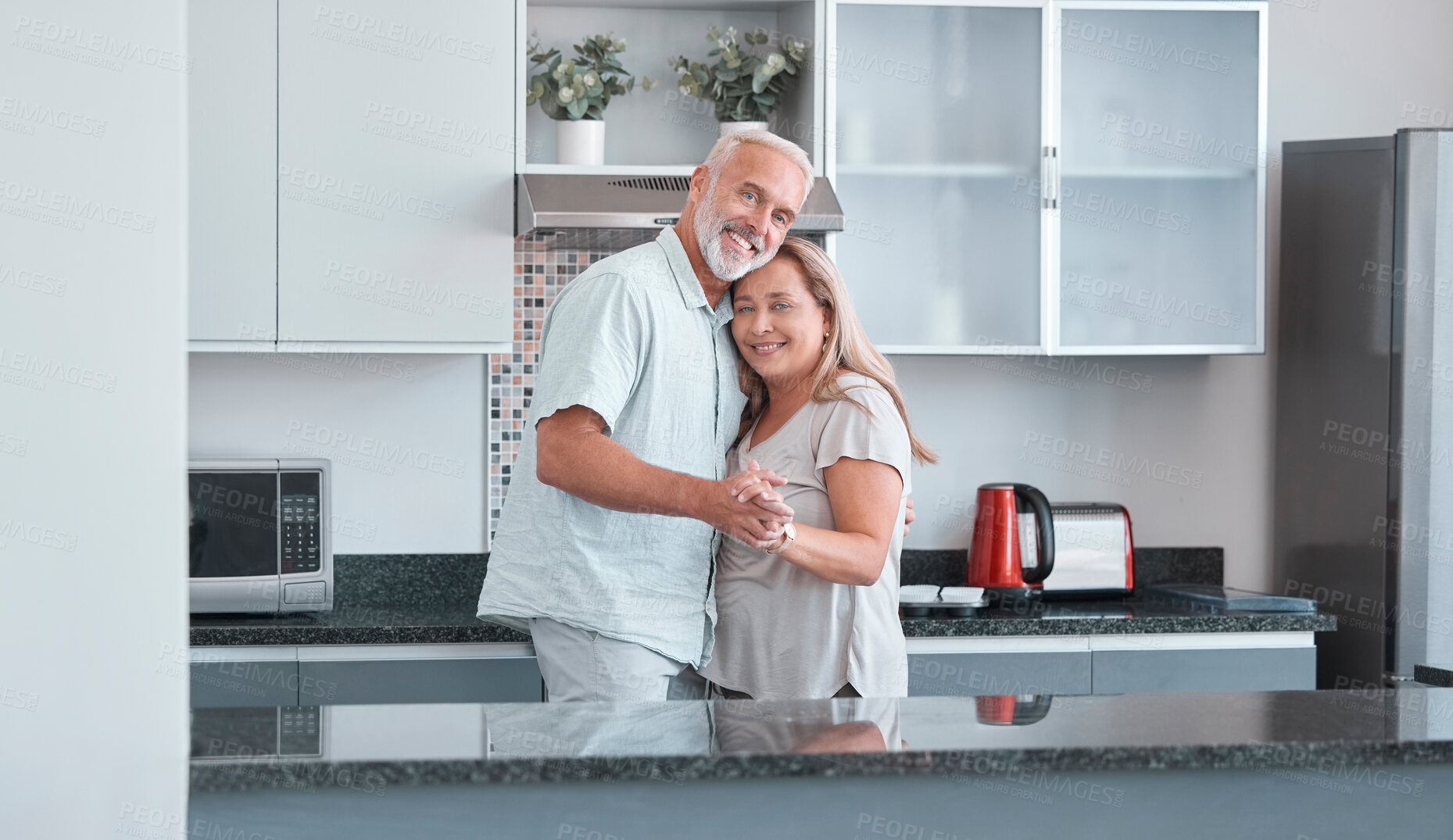 Buy stock photo Love, marriage and dance with a senior couple in the kitchen of their home together for bonding or romance. Portrait, happy and smile with a mature man and woman romantic dancing in their house