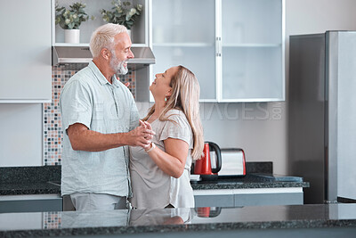 Buy stock photo Love, dance and a senior couple in kitchen of home together enjoying weekend time and celebrate life with smile. Retirement, happiness and health, a happy man and woman dancing in house or apartment.