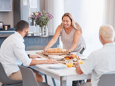Happy family, thanksgiving or bonding with healthy food on dining table in house or home for holiday party. Smile, happy or mature woman with festive or traditional buffet meal for men in celebration