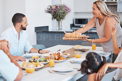 Buy stock photo Lunch celebration, party and big family eating at a dining room table with love, smile and communication. Food, relax and senior woman serving dinner or breakfast to celebrate a holiday together