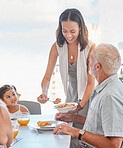 Family, lunch and woman serve food to father in the family home at the dining table for nutrition, diet and wellness. Meal, mother and daughter eating meal with grandfather at home for bonding 