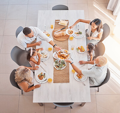 Buy stock photo Family, lunch and food at the table with big family bonding, sharing and eating together at the dining table. Meal, top view and family home with a mother, father and grandparents and kids eat 