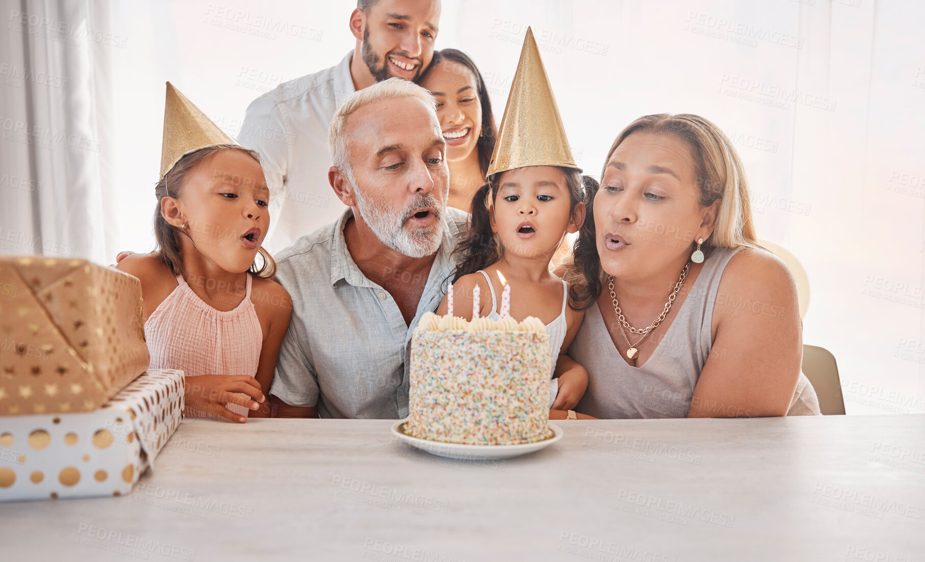 Buy stock photo Big family celebration party, birthday cake and children blow candle fire to celebrate annual event with present and gift box. Love bond, youth growth congratulations and childhood memory of sisters