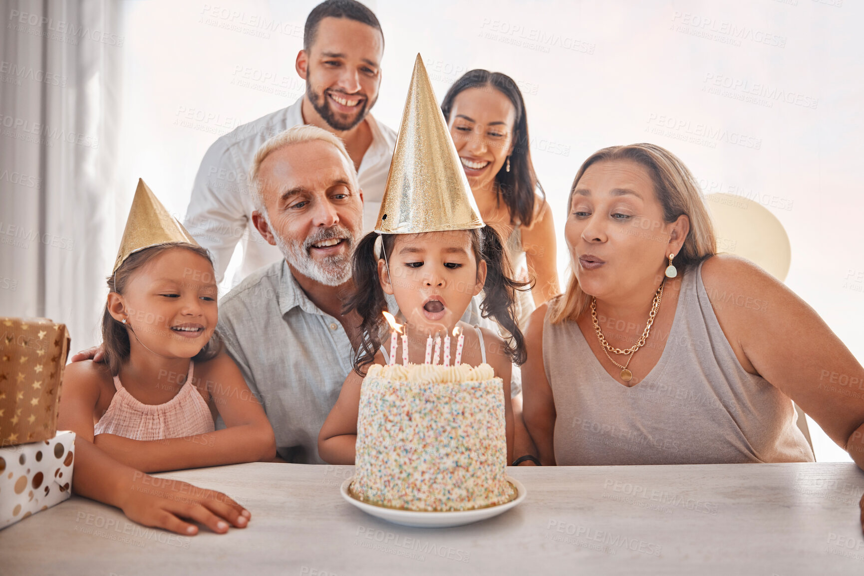 Buy stock photo Girl, birthday cake and candles for happy family at party, celebrate or together in home. Child, black family and celebration with cake, birthday party or event in house with happy birthday surprise