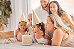 Family, kids and birthday cake with a child and her big family celebrating with a party for fun event. Generations, mother and father with grandparents and grandkids celebrate with dessert or candles