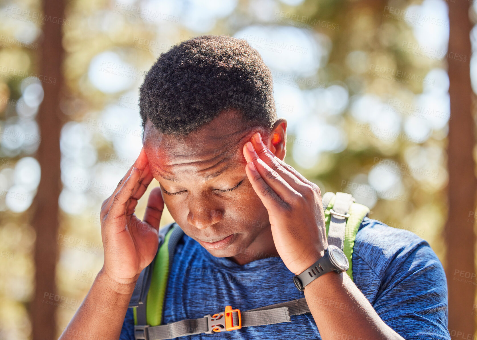 Buy stock photo Headache, stress hiking with a black man athlete holding his temples in pain while walking in the forest. Nature, fitness and migraine with a male hiker in the woods for exercise or training