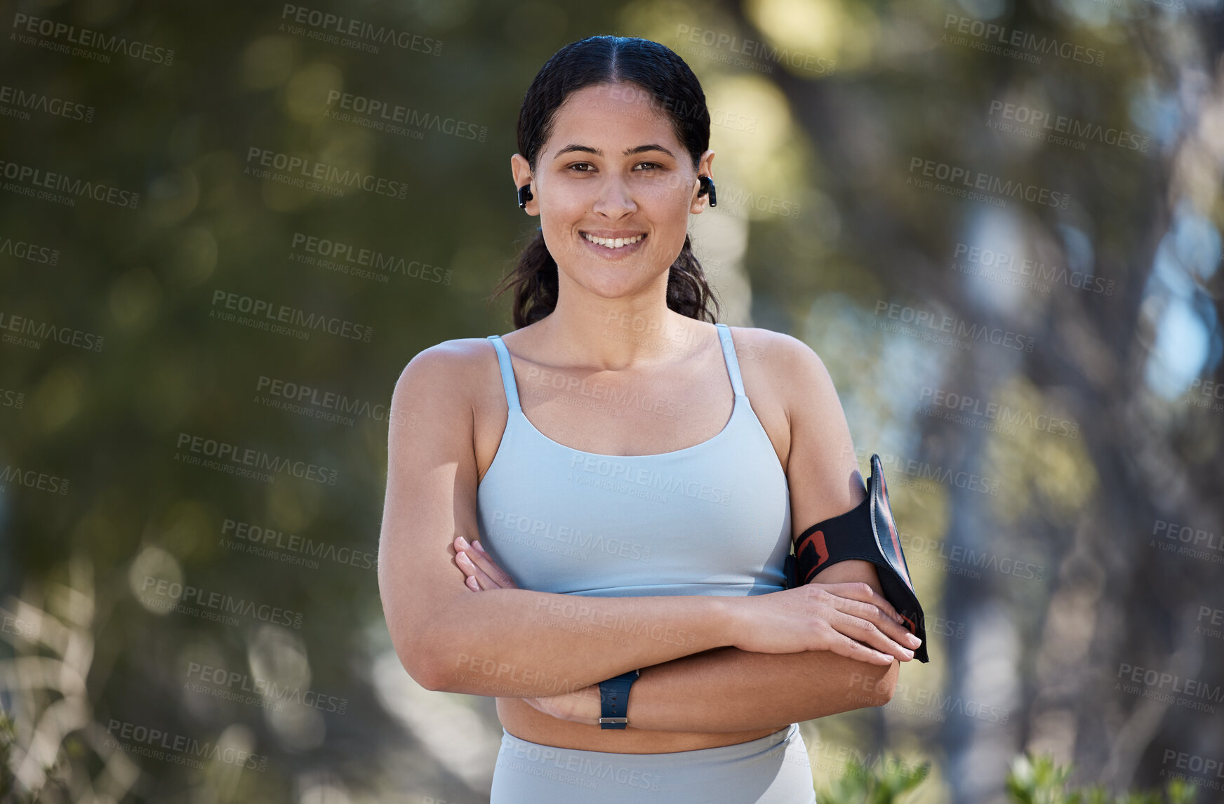 Buy stock photo Portrait, exercise and woman, arms crossed and motivation in park with music, fitness and arm band. Happy young athlete, healthy lifestyle or outdoor training, runner and wellness, energy and workout