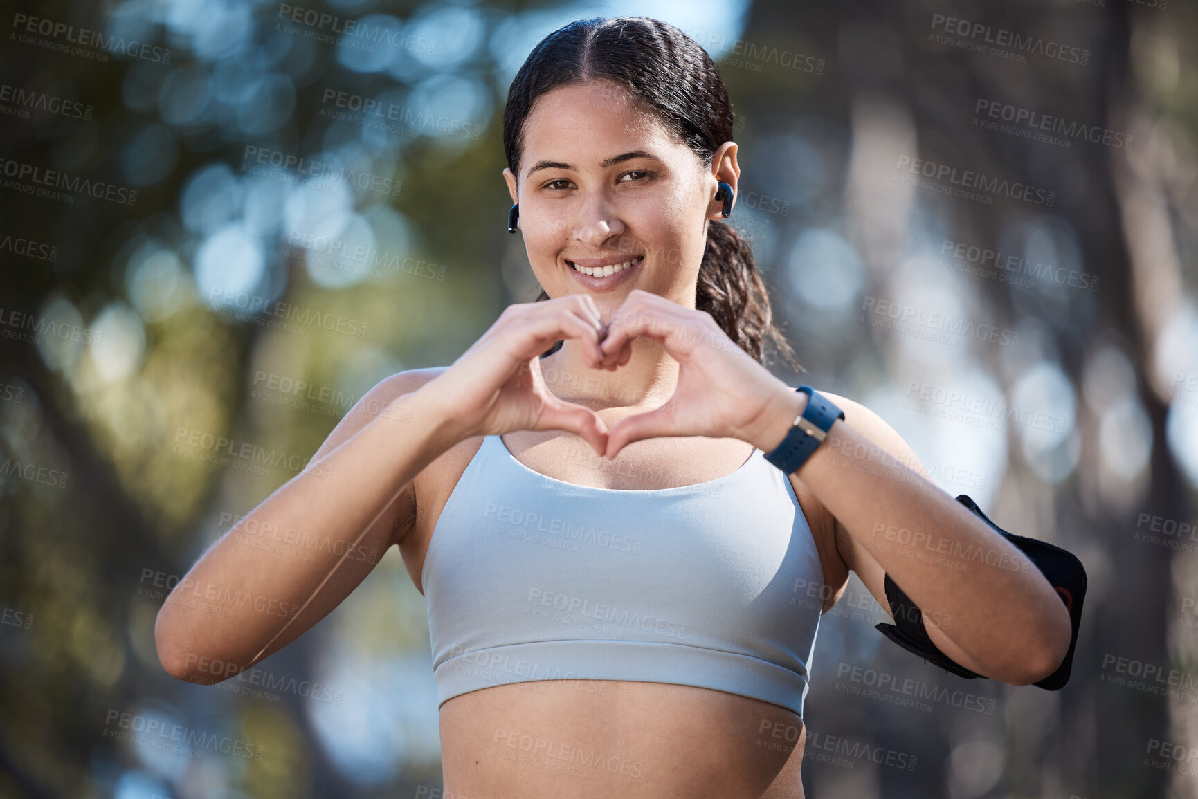 Buy stock photo Fitness portrait, heart hands and woman in nature with sign for affection or love emoji outdoors. Health, wellness and female athlete in park with hand symbol for support while preparing for training