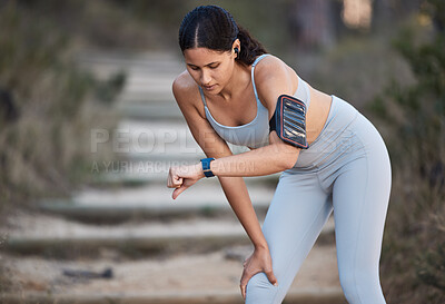 Buy stock photo Fitness, runner and woman running with smartwatch, check time and health monitor, heart rate and cardio during workout outdoor. Exercise, break and training for marathon or wellness with sport tech.