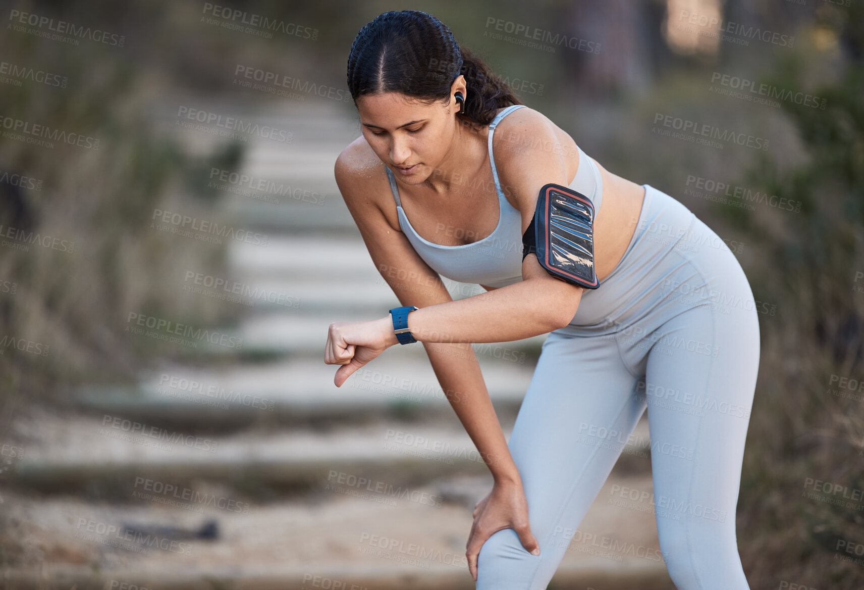 Buy stock photo Fitness, runner and woman running with smartwatch, check time and health monitor, heart rate and cardio during workout outdoor. Exercise, break and training for marathon or wellness with sport tech.