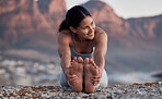 Fitness, yoga and stretching with a woman on the beach for wellness, mental health or exercise in nature. Environment, peace and thinking with a female athlete doing a warm up for zen training