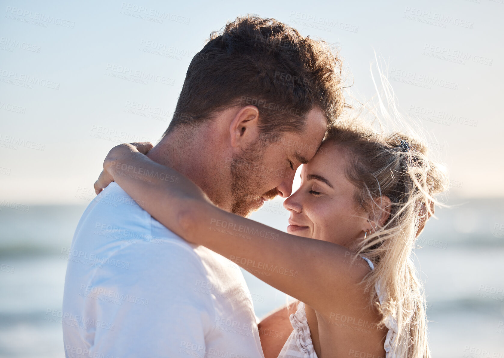 Buy stock photo Couple, love and hug on beach eyes closed, smile and happy for relax travel vacation or quality time together. Happiness, man and woman hugging for romance marriage, honeymoon or holiday in sunshine